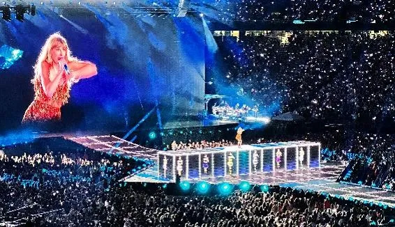 Crowd watching a concert under blue stage lights
