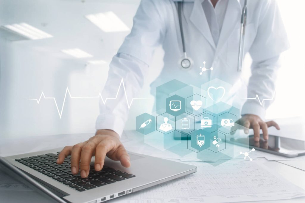 Person in medical attire using a laptop with superimposed health icons