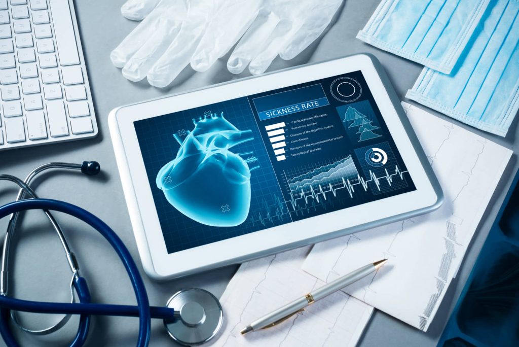 Medical tablet showing health data dashboards beside a stethoscope