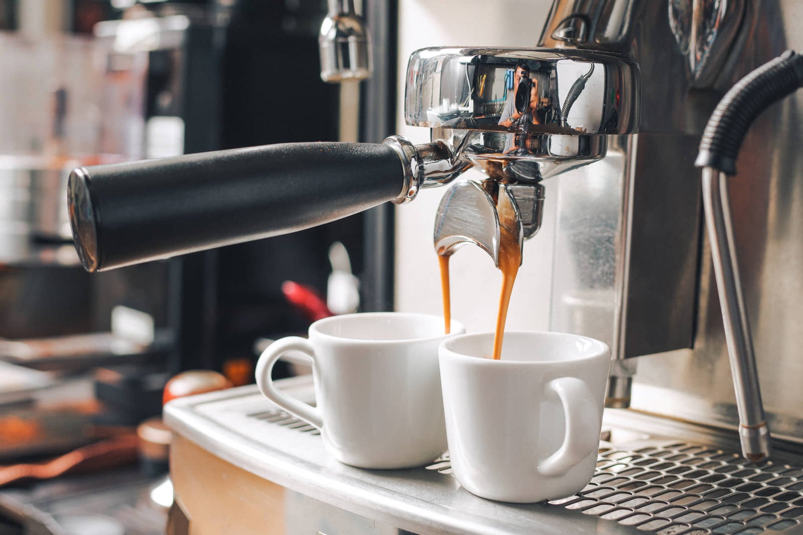 Espresso machine pouring coffee into two cups